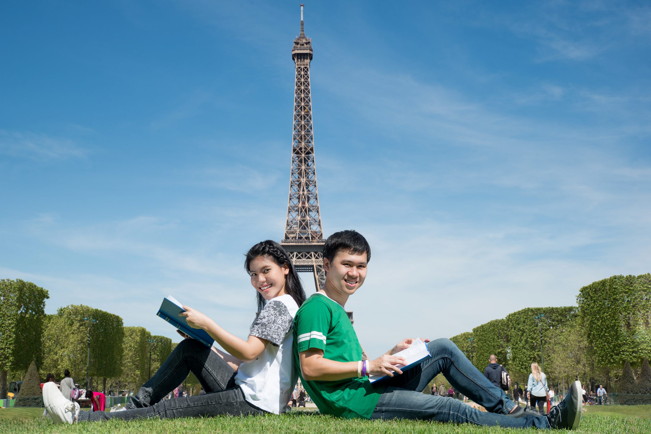 asian-couple-student-reading-book-together-outdoors-park-near-eiffel-tower-paris-france-scaled-1